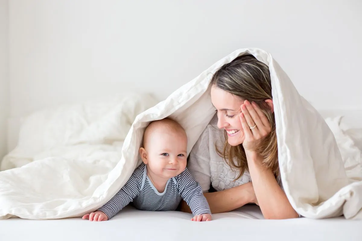 Mother and baby wrapped in a blanket